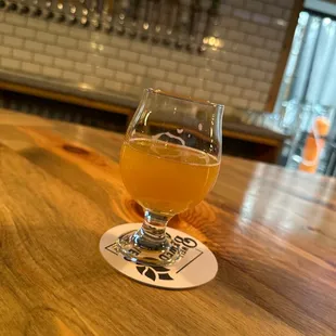 a glass of beer on a bar