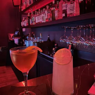 two cocktails on a bar