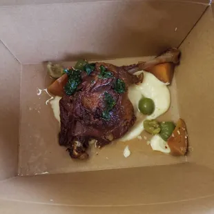 Confit of duck entree in a to-go box.  Terrific.