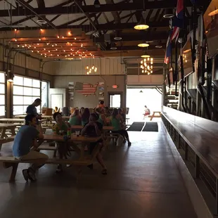a large group of people sitting at picnic tables