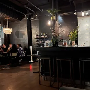 a group of people sitting at a bar