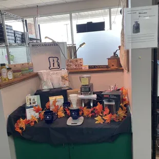 a coffee station with a black table cloth