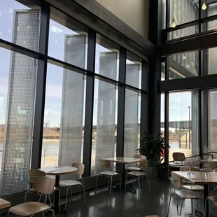 tables and chairs in a restaurant with large windows