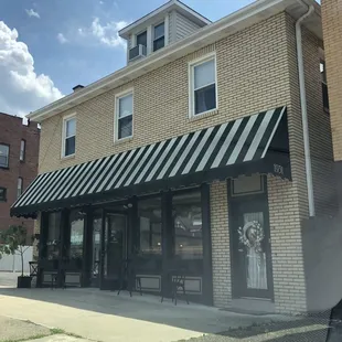 Storefront with a couple of outdoor tables