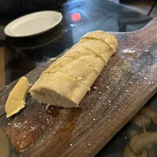 Warm Italian bread drizzled with olive oil and sprinkled with Parmesan cheese. Served with fresh real butter.