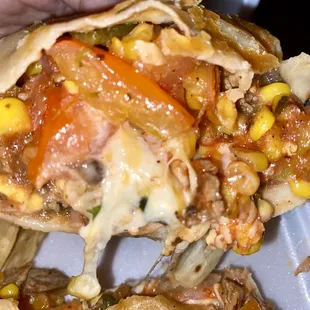 Grilled steak burrito. Has corn, fajita veggies,cheese, sour cream, and guacamole on the side