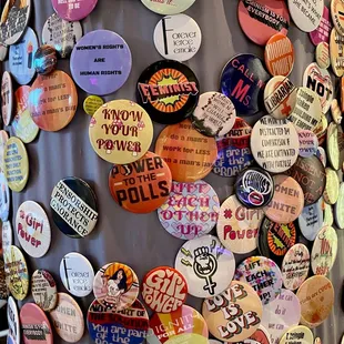Feminist campaign pins on the walls.
