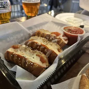 a tray of hotdogs with cheese and ketchup