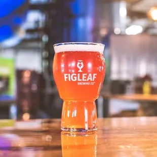 a glass of beer on a bar