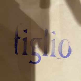 the word figlio on a paper bag
