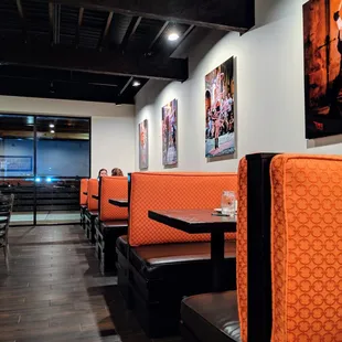 Inside. Dining room booths and colorful photograph wall decor.