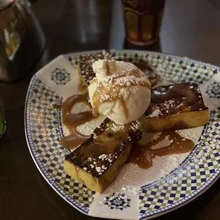 a plate of dessert with ice cream and caramel