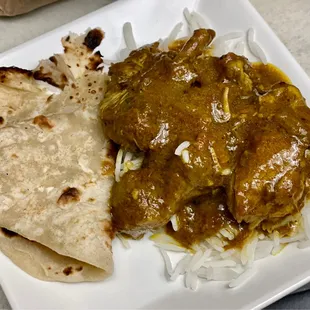 Chicken curry in rice with roti