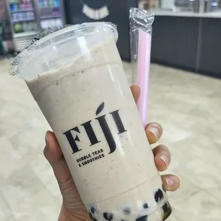 a hand holding a cup of bubble tea