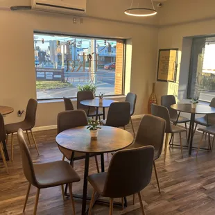 tables and chairs in front of a window