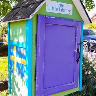 Free Little Library box with a painted Swedish flag  10-07-2024