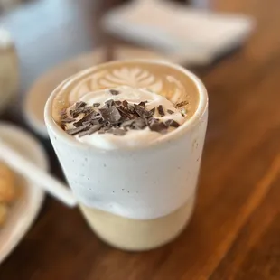 a cup of coffee and a pastry on a table