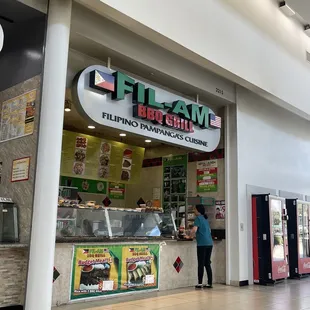 a woman standing in front of a restaurant