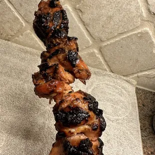 a skewer of meat on a stick