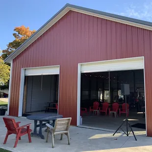 a red barn with a table and chairs