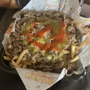 Carne asada fries with the red and green salsa.