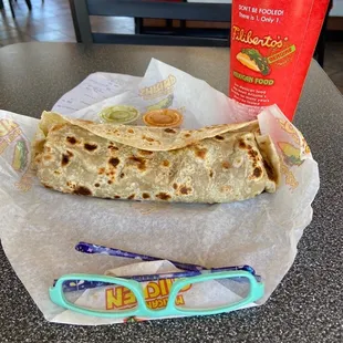 How big it is compared to glasses.  Hot sauce is "hot" but I'm a wimp when it comes to hot sauce.