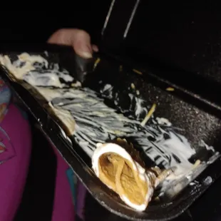 a person holding a tray of food