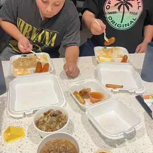 From top left to right: Pancit with longonizas; rice with longonizas; freshly made lumpia; pork adobo; sisig