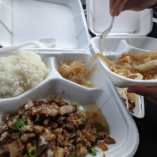 a tray of rice, meat, and vegetables
