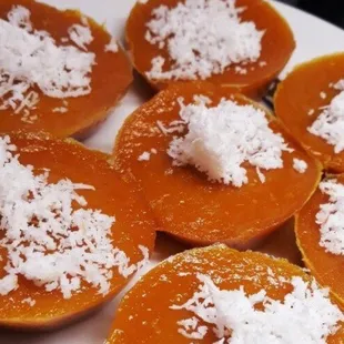 a plate of sweet potatoes with coconut flakes