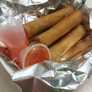 a plate of food wrapped in aluminum foil