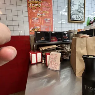 a person&apos;s hand reaching for a piece of pizza