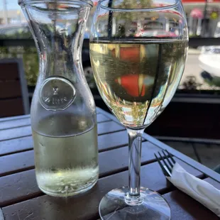 a glass of wine and a pitcher