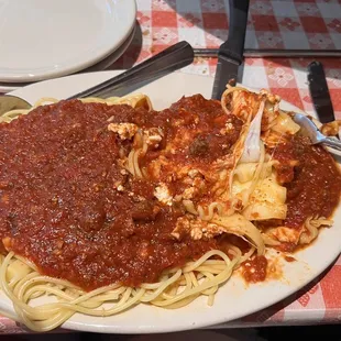 2 item plate. Spaghetti and lasagna with meat sauce  We were also served warm French bread and butter.
