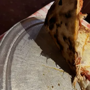 Bottom side of pizza it looks burnt but it's not it's good the dough is crispy and very cheesy