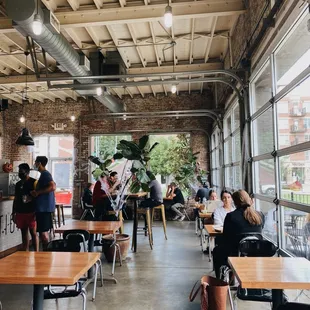 people sitting at tables in a cafe