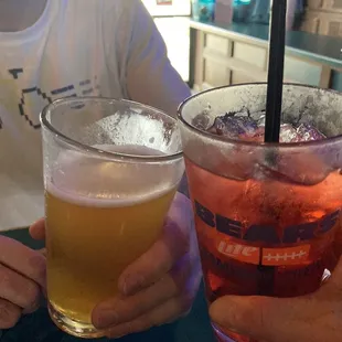 two people sitting at a table with drinks