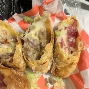 Reuben Egg Rolls that show one with grey meat and smells off.