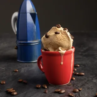 a cup of ice cream and coffee beans