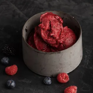 a bowl of raspberries and blueberries