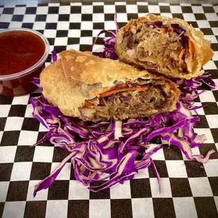 a pulled pork sandwich on a checkered tablecloth