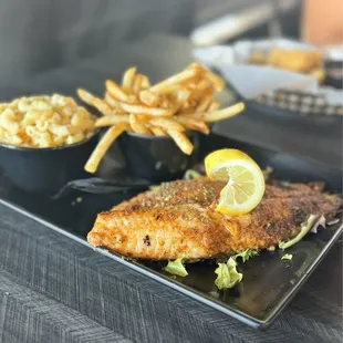 Blackened catfish with fries and Mac and cheese side.