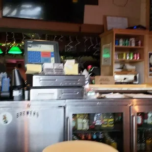 a man behind the counter of a restaurant