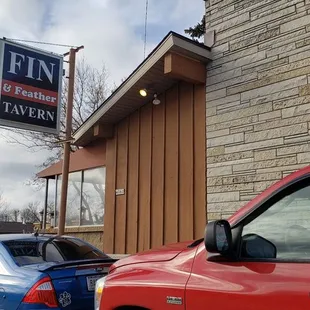 two cars parked in front of a building