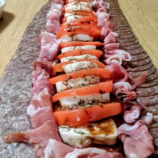 long platter of meats and vegetables