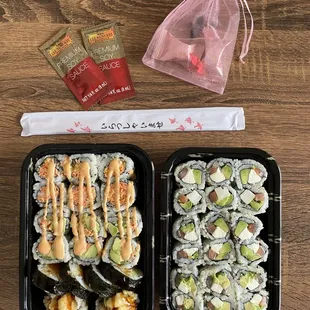 (left container, top to bottom): Spicy Crab Meat Roll, Spicy California Roll, Sweet Potato Tempura Roll; (right container) Philadelphia Roll
