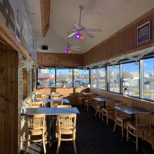 the inside of a restaurant with tables and chairs