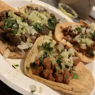 three tacos on a paper plate