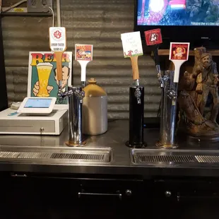 a bar with beer taps and a television