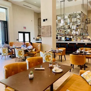 a dining room with a bar and a bar in the background